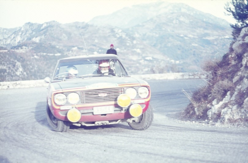 A Fiat 124 Vignale coupe, Monaco plate E544, on a snowy mountain hairpin in the Alpes-Maritimes during the 1969 rally